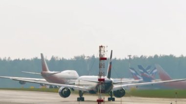 MOSCOW, RUSSIAN FEDERATION - JULY 29, 2021: Boeing 777 of Aeroflot Airlines acceleration before takeoff at Sheremetyevo Airport, Moscow. Airplane departure, rear view