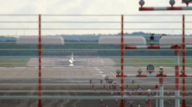 Landing lights at the airport. Private jet picks up speed and takes off, front view of the runway. Tourism and travel concept