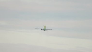 Passenger aircraft takeoff, rear view. Commercial jet airplane flying away. Tourism and travel concept