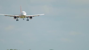 AMSTERDAM, THE NETHERLANDS - JULY 26, 2017: Airbus A319 of EasyJet approaching before landing at Schiphol Airport, Amsterdam. Tourism and travel concept