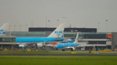 AMSTERDAM, THE NETHERLANDS - JULY 27, 2017: Boeing 737 airline KLM rides on the taxiway in front of the airport terminal. Travel concept