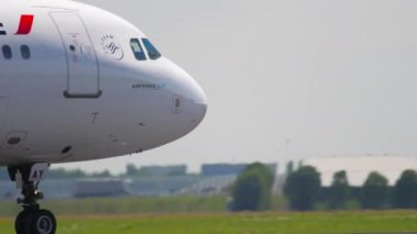 AMSTERDAM, THE NETHERLANDS - JULY 26, 2017: Passenger plane of AirFrance braking after landing, medium shot. Tourism and travel concept