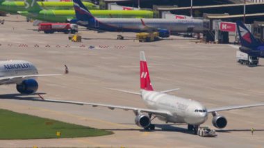 SOCHI, RUSSIA - JULY 29, 2022: Passenger widebody aircraft Airbus A330 Nordwind on the taxiway at Sochi airport. Tourism and air travel concept