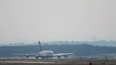 FRANKFURT AM MAIN, GERMANY - JULY 17, 2017: Huge double-deck four-engine passenger Airbus A380 of Lufthansa taking off at Frankfurt am Main airport, long shot. Tourism and travel concept.