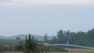 PHUKET, THAILAND - NOVEMBER 28, 2019: Long shot of commercial plane Airbus A319 of Bangkok Airways take off at Phuket airport HKT. Tourism and travel concept.