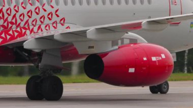 MOSCOW, RUSSIAN FEDERATION - JULY 28, 2021: Airplane of Rossiya taxiing at Sheremetyevo Airport SVO. View of the engine and landing gear of the aircraft