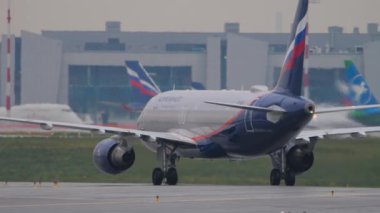 MOSCOW, RUSSIAN FEDERATION - JULY 28, 2021: Airbus A320 of Aeroflot taxiing on the runway, rear view. Tourism and travel concept