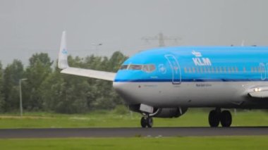 AMSTERDAM, THE NETHERLANDS - JULY 27, 2017: Boeing 737 of KLM braking after landing at Schiphol Airport, Amsterdam. Civil aircraft arrival