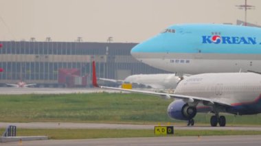 MOSCOW, RUSSIAN FEDERATION - JULY 28, 2021: Boeing 737 of Aeroflot taxiing on the runway at Sheremetyevo Airport. Boeing 747 Korean Air Cargo on the background. Jumbo jet on the taxiway