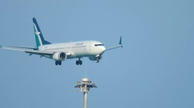 PHUKET, THAILAND - NOVEMBER 26, 2016: Boeing 737 MAX 8, 9V-MBC of SilkAir landing at Phuket Airport, medium shot side view. Tourism and travel concept