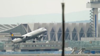 FRANKFURT AM MAIN, GERMANY - JULY 17, 2017: Passenger jet plane Airbus A321 of Lufthansa takeoff, slow motion. Side view, passenger plane departure and climb. Fraport, Frankfurt, Germany
