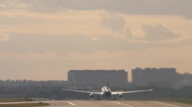 Passenger jet plane acceleration and takeoff, rear view. Commercial aircraft flying away. Tourism and travel concept