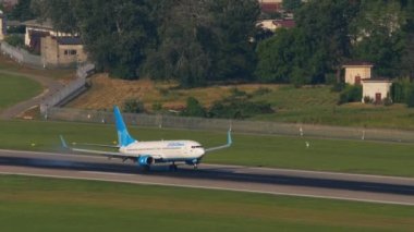 SOCHI, RUSSIA - JULY 30, 2022: Lowcost aircraft Boeing 737 of Pobeda Airlines landing and braking at Sochi airport, long shot. Tourism and travel concept