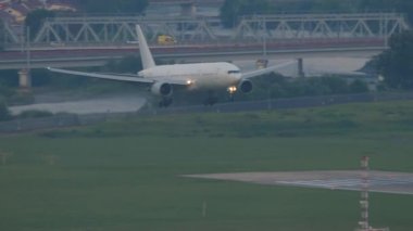 Passenger plane approaching landing. Airliner touching the runway and braking. Tourism and travel concept