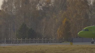 NOVOSIBIRSK, RUSSIAN FEDERATION - OCTOBER 20, 2021: Passenger airplane Airbus A320, VQ-BCH of S7 airlines taxiing at Tolmachevo Airport OVB. Airplane on the background of the autumn forest
