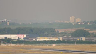 FRANKFURT AM MAIN, GERMANY - JULY 19, 2017: Passenger plane Embraer of Lufthansa descending before landing at Frankfurt Airport, Germany. Spotting