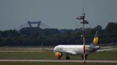 DUSSELDORF, GERMANY - JULY 23, 2017: Passenger airplane of Condor takeoff at Dusseldorf airport, slow motion. Jet plane on the airfield. Tourism and aviation concept. German airline