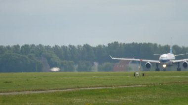 Unrecognizable airliner accelerating to take off. Airplane on the airfield on a summer day. Haze on the runway