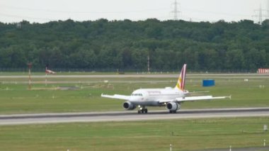 DUSSELDORF, GERMANY - JULY 23, 2017: Passenger plane of Germanwings braking after landing at Dusseldorf International Airport, side view. Tourism and travel concept