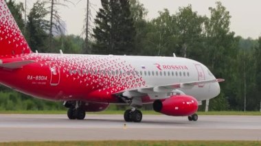 MOSCOW, RUSSIAN FEDERATION - JULY 28, 2021: Sukhoi Superjet 100-95B, RA-89014 of Rossiya taxiing at Sheremetyevo Airport SVO. Jet commercial aircraft on the airfield. Tourism and travel concept