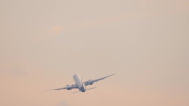Jet plane climb after takeoff. Airplane turn in the sky, background. Departing flight, rear view