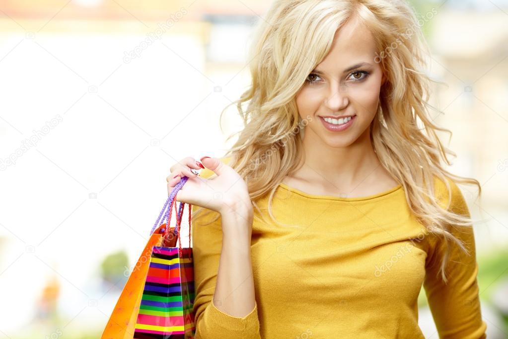 Smiling girl with shopping bags