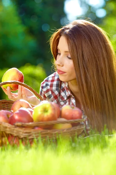 Bella donna in giardino con mele — Foto Stock