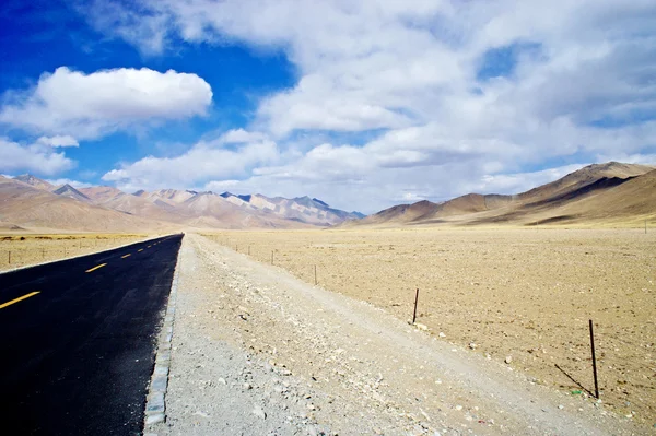 Yellowish mountain road view in tibet of China Royalty Free Stock Images
