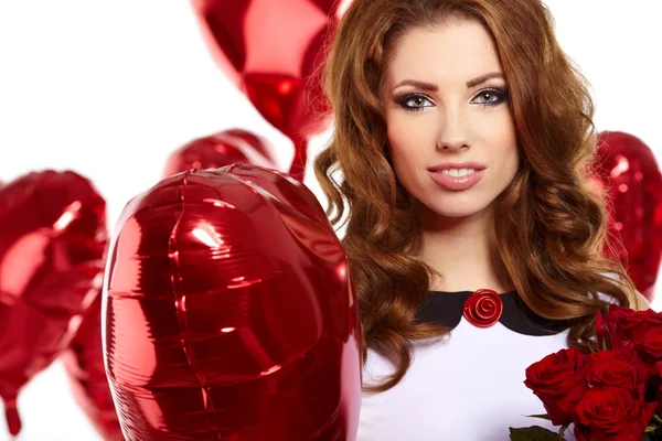 Woman with red heart balloon Stock Image