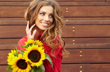 Fashion woman with sunflower at outdoor. clipart