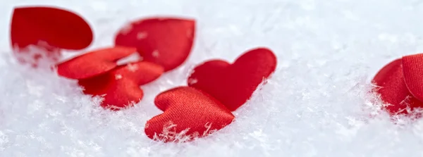 Red hearts on snow — Stock Photo, Image