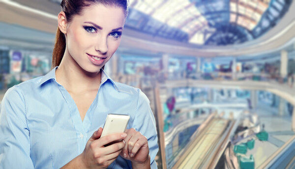 Woman talking on the phone at the shopping mall