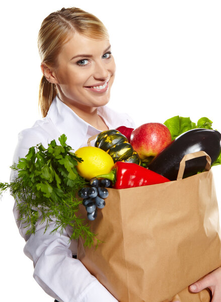 beautiful young woman with vegetables and fruits in shopping bag