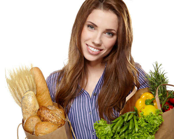 Young woman holding a grocery bag full of bread