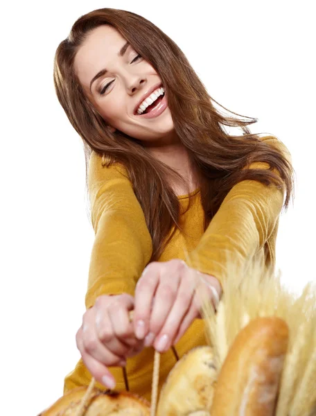 Young woman holding a grocery bag full of fresh and healthy food Royalty Free Stock Images