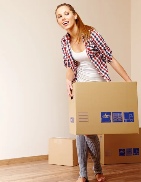 Young beautiful woman with packages for house moving — Stock Photo, Image