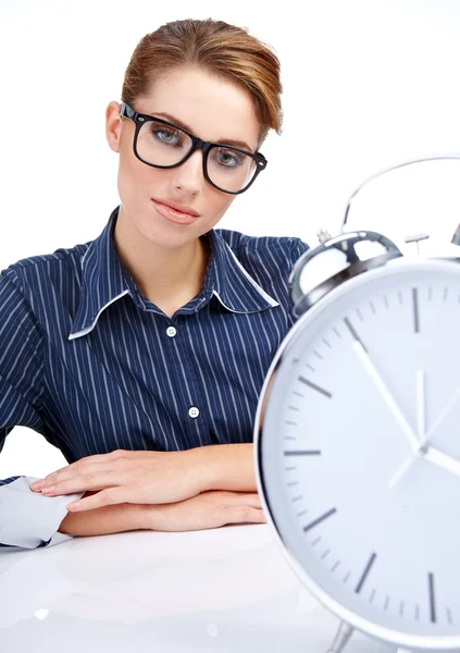 Young attractive woman with big clock on white. Stock Image