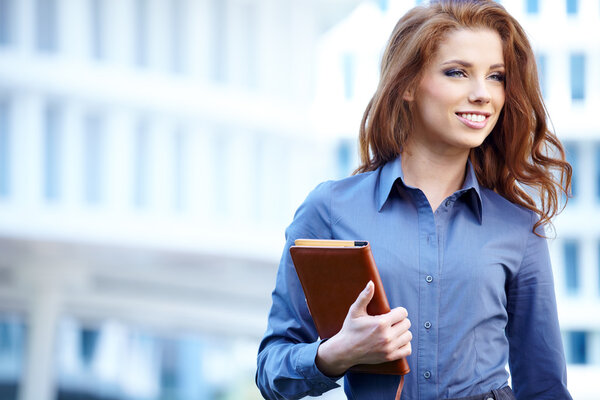 Beautiful business woman on the background of the modern office