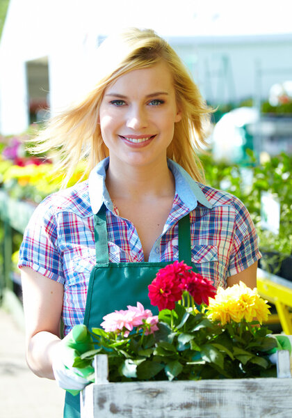 Florists woman working with flowers at a greenhouse.