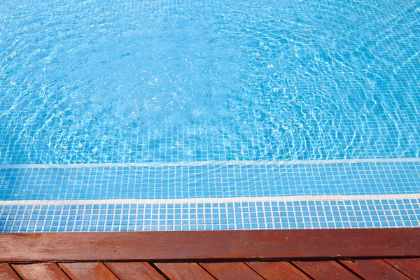 Fragment of a swimming pool and wooden floor — Stock Photo, Image