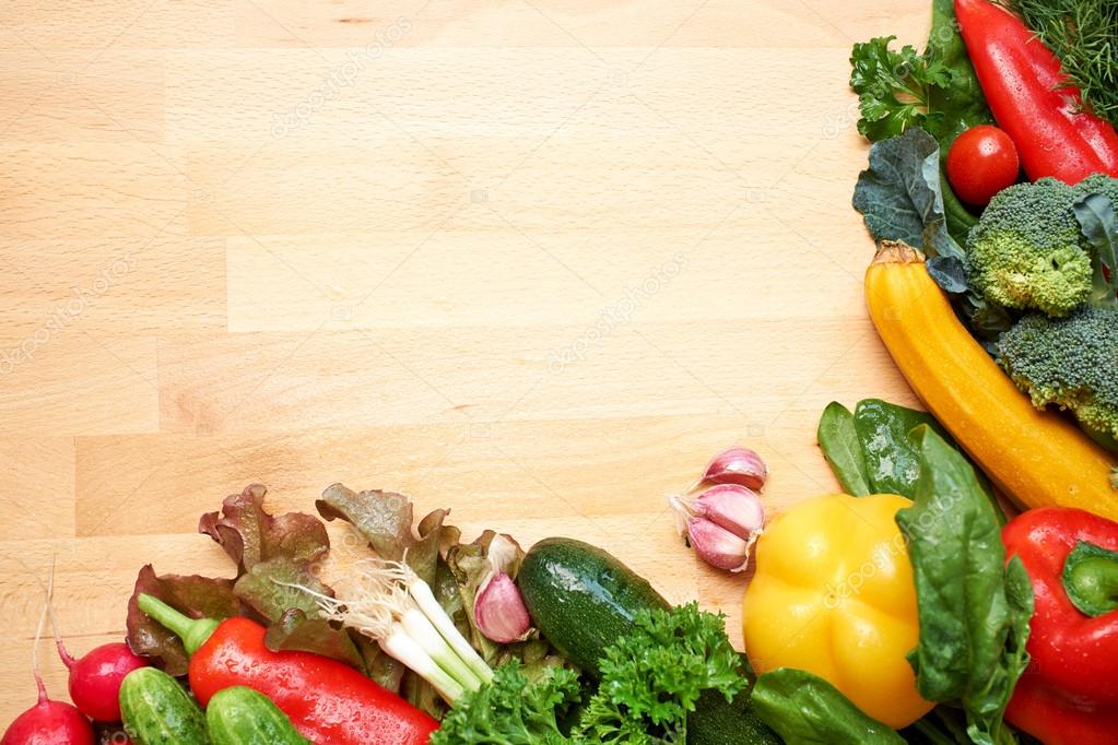 Healthy organic vegetables on a wood background Stock Photo by