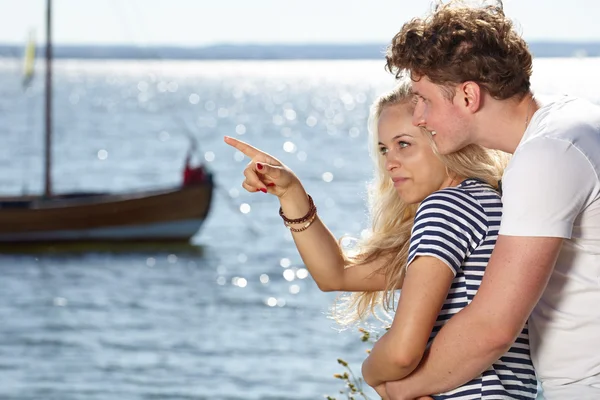 Young happy couple having fun on the beach. — Stock Photo, Image