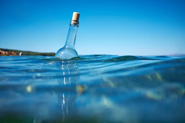 Bottle with a message in water — Stock Photo, Image