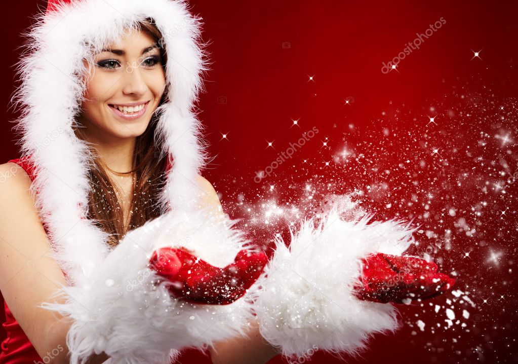 Photo of fashion Christmas girl blowing snow.