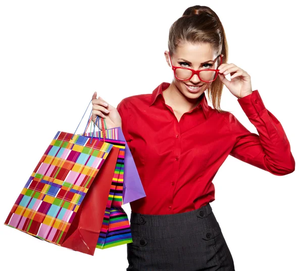 Shopping woman holding bags, isolated on white studio background — Stock Photo, Image