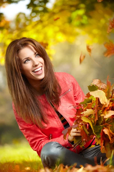 Young woman with autumn leaves in hand Royalty Free Stock Photos