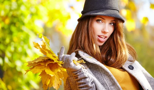 Frau steht im Herbst in einem Park — Stockfoto