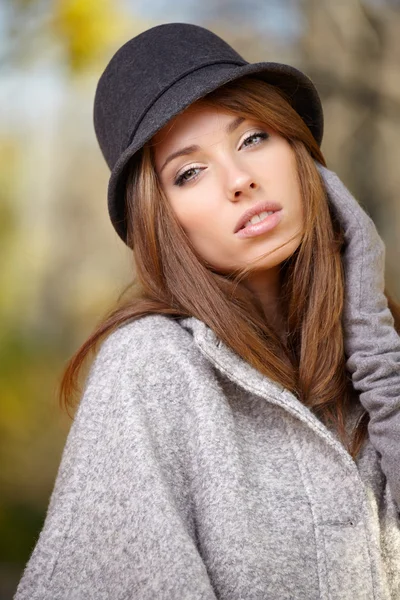 Elegant woman standing in a park in autumn Stock Picture