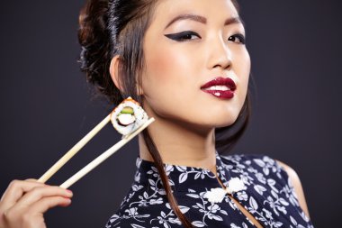 Asian woman eating sushi clipart