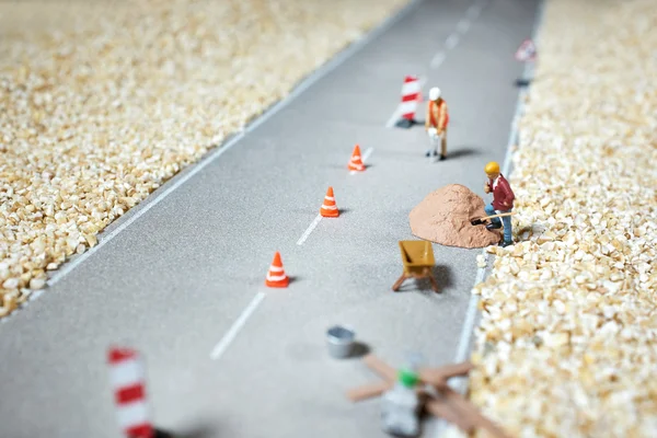 Road renovation in progress . Macro figurine — Stock Photo, Image